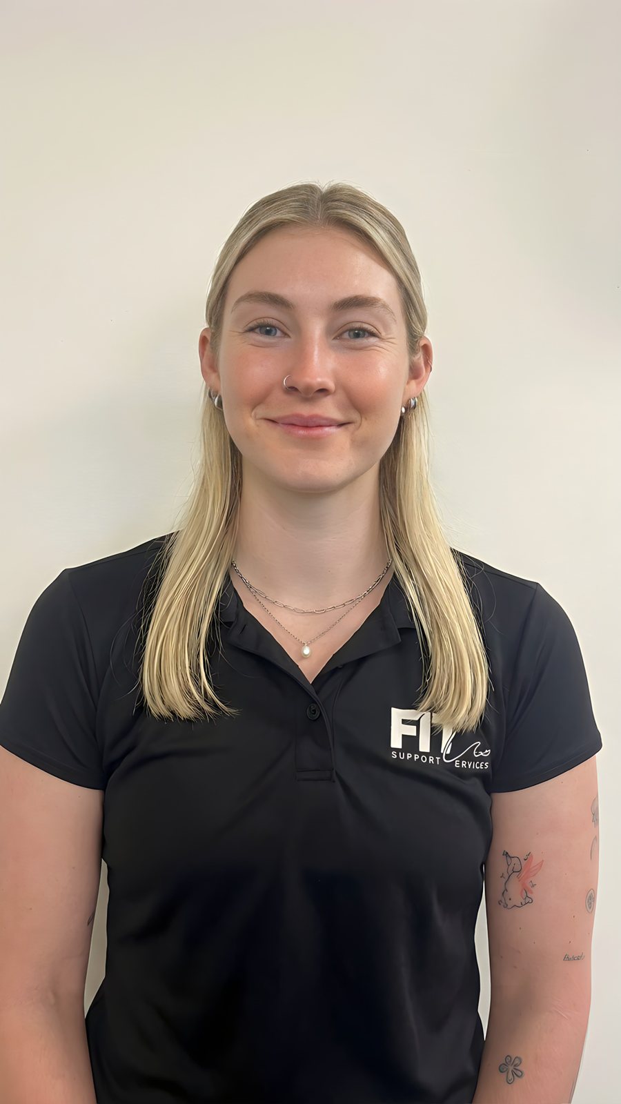Portrait of Brooke, FITCare support worker, in the black FITCare polo